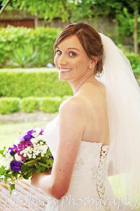 Bride glancing over her shoulder at camera - wedding photography sydney